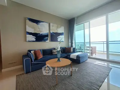 Modern living room with stylish blue sofa and balcony view