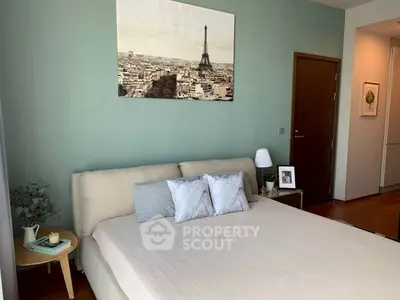 Cozy bedroom with elegant decor and Eiffel Tower artwork