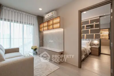 Modern living room with elegant decor and view into cozy bedroom