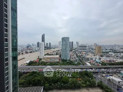 Stunning cityscape view from high-rise building overlooking river and skyline.