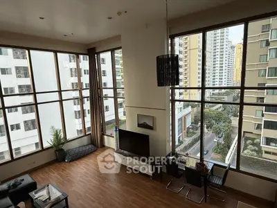 Spacious corner unit living room with floor-to-ceiling windows and city view