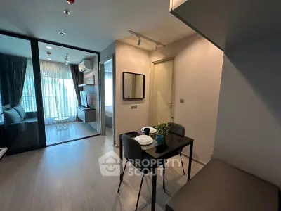 Modern apartment interior with dining area and view into living room and bedroom