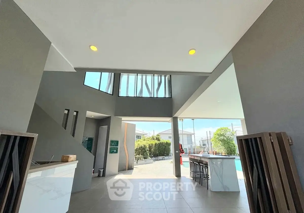 Modern open-air entrance with pool view and sleek design