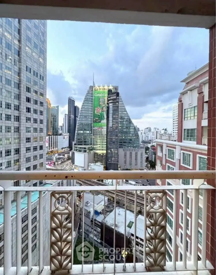 Stunning cityscape view from a high-rise balcony in a bustling urban area.