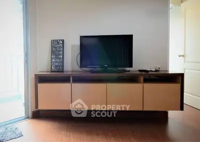 Modern living room with sleek TV stand and balcony view