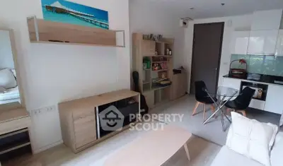 Modern living room with open kitchen and stylish furniture in a cozy apartment.