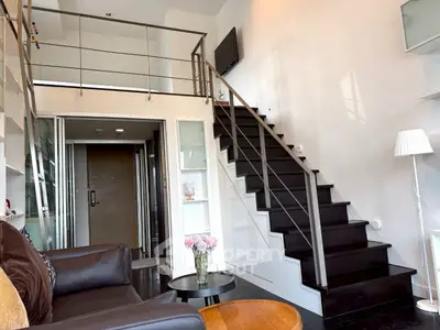 Modern loft apartment with sleek staircase and stylish living area