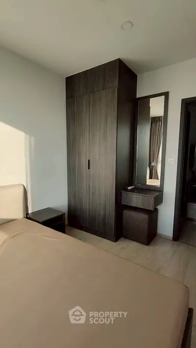 Modern bedroom with sleek wardrobe and vanity in natural light