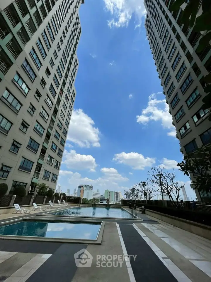 Luxurious high-rise apartment with stunning pool and city view, perfect for urban living.