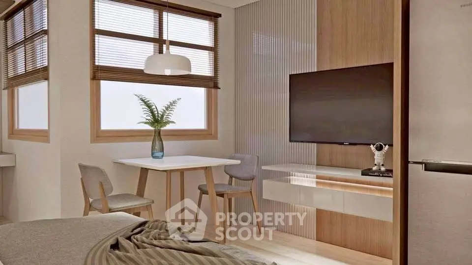 Modern living room with stylish decor, featuring a wall-mounted TV and cozy dining area.