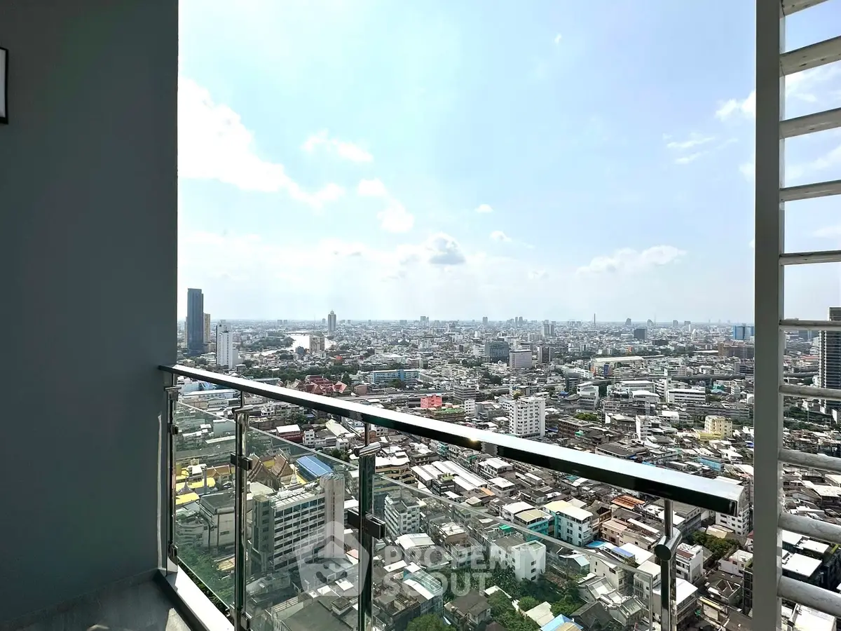 Stunning high-rise balcony view overlooking the city skyline and river, perfect for urban living.