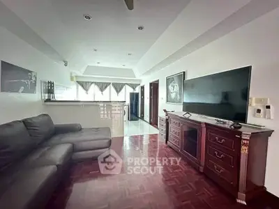 Spacious living room with elegant wooden flooring and modern furnishings in a stylish apartment.