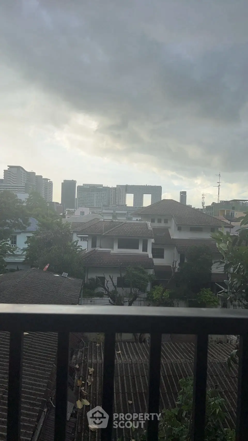Stunning urban skyline view from a residential balcony, showcasing cityscape and modern architecture.