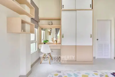 Modern bedroom with built-in wardrobe and stylish desk area