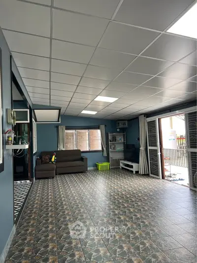 Spacious living room with modern decor and large windows for natural light.
