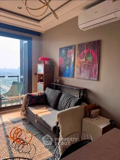 Modern living room with city view, stylish decor, and cozy seating area.
