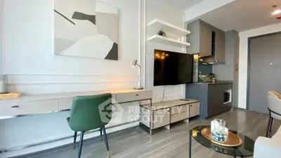 Modern living room with sleek furniture and integrated kitchen area, perfect for urban living.
