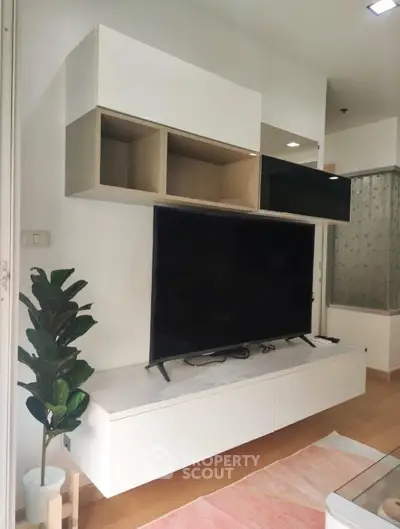 Modern living room with sleek TV unit and stylish shelving, perfect for contemporary urban living.