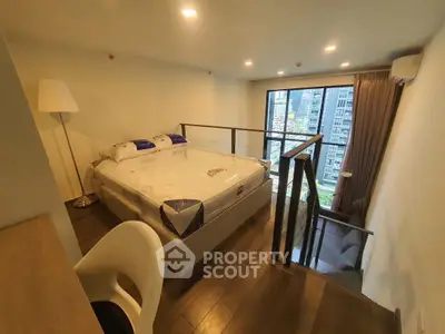 Modern loft bedroom with city view, featuring a cozy bed and stylish decor, perfect for urban living.