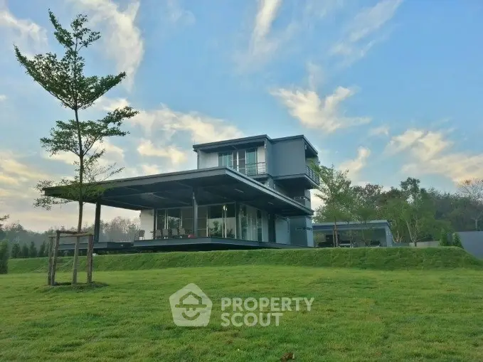 Modern two-story house with expansive lawn and scenic view