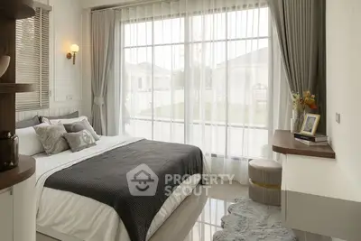 Elegant bedroom with large window and stylish decor in modern home