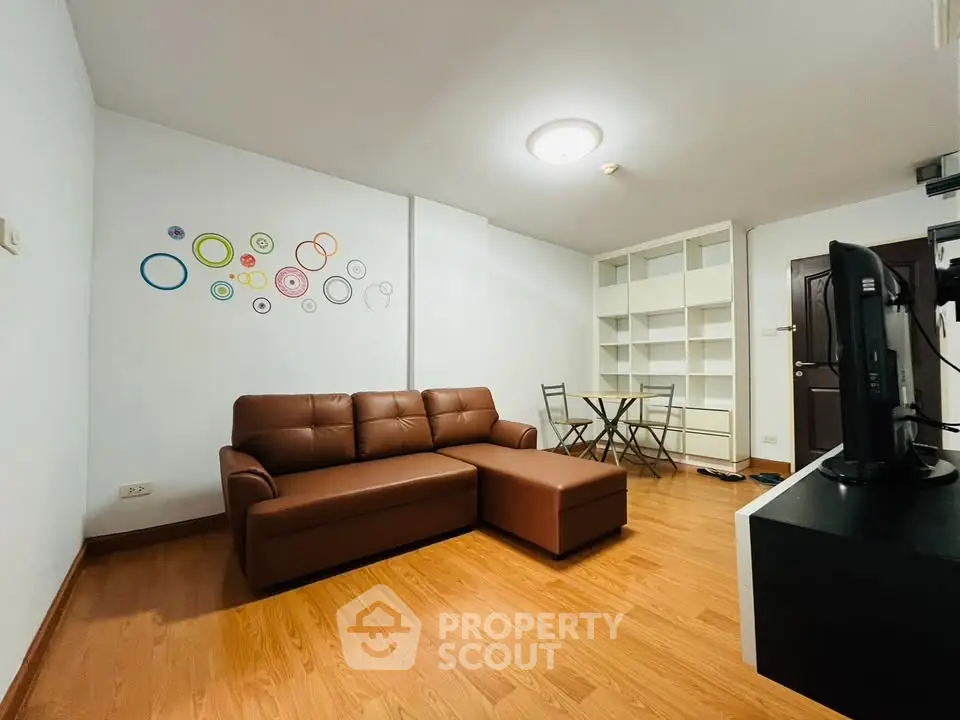 Modern living room with brown leather sofa and stylish wall art