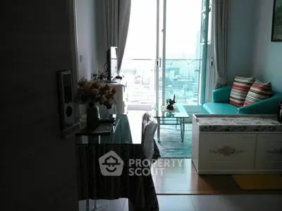 Cozy living room with city view, modern decor, and natural light.