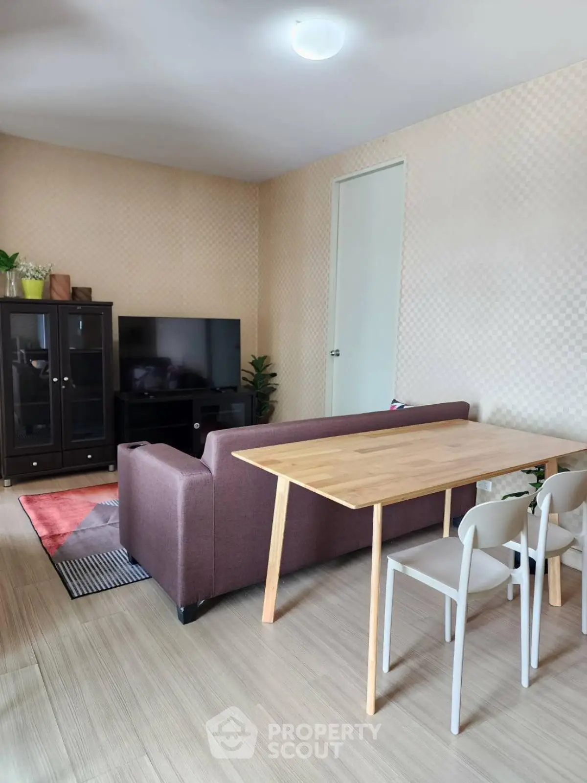 Modern living room with stylish furniture and TV setup, perfect for cozy gatherings.