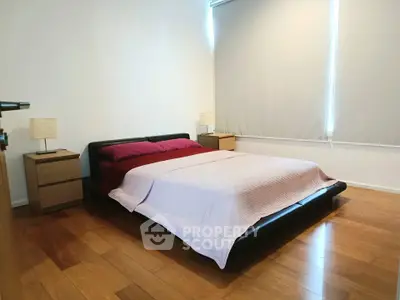 Spacious bedroom with modern design and wooden flooring