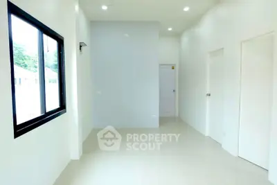 Spacious and bright empty room with large window and modern design