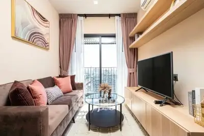 Stylish living room with modern decor and city view balcony, perfect for urban living.