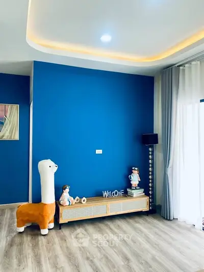 Stylish living room with vibrant blue accent wall and modern decor