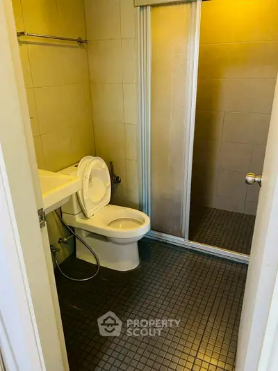 Compact bathroom with shower and modern fixtures in a cozy real estate property.