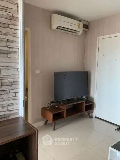 Modern living room with sleek TV stand and air conditioning unit, perfect for comfortable living.
