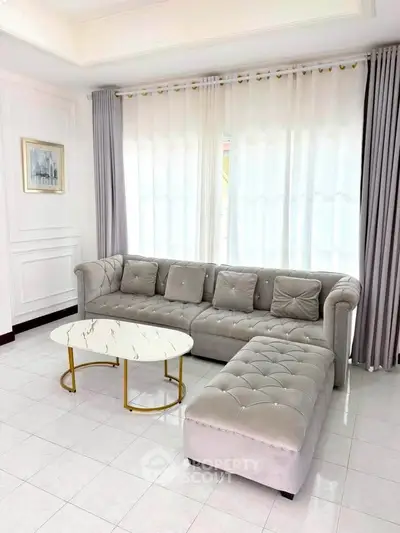 Elegant living room with plush sofa and chic marble coffee table, perfect for modern comfort and style.