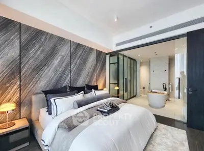 Luxurious modern bedroom with ensuite bathroom featuring elegant decor and stylish lighting.