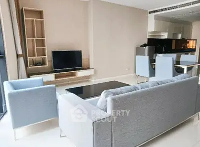 Modern living room with sleek furniture and open kitchen layout