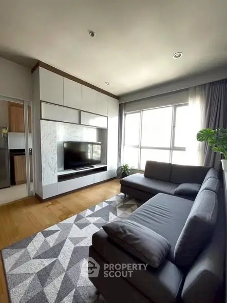 Modern living room with stylish furniture and large windows for natural light.