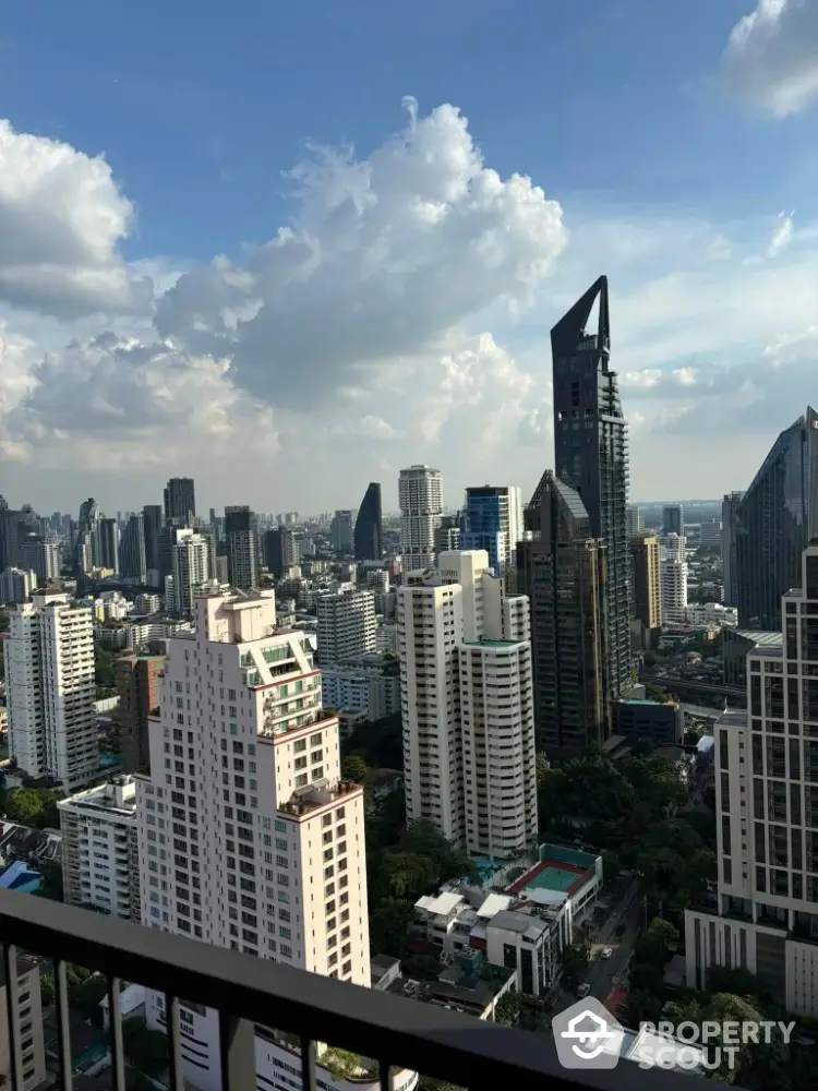 Stunning cityscape view from high-rise balcony overlooking modern skyline.