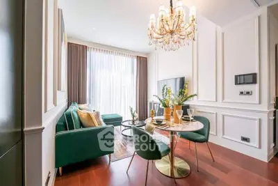 Luxurious living room with elegant chandelier and stylish decor in modern apartment.