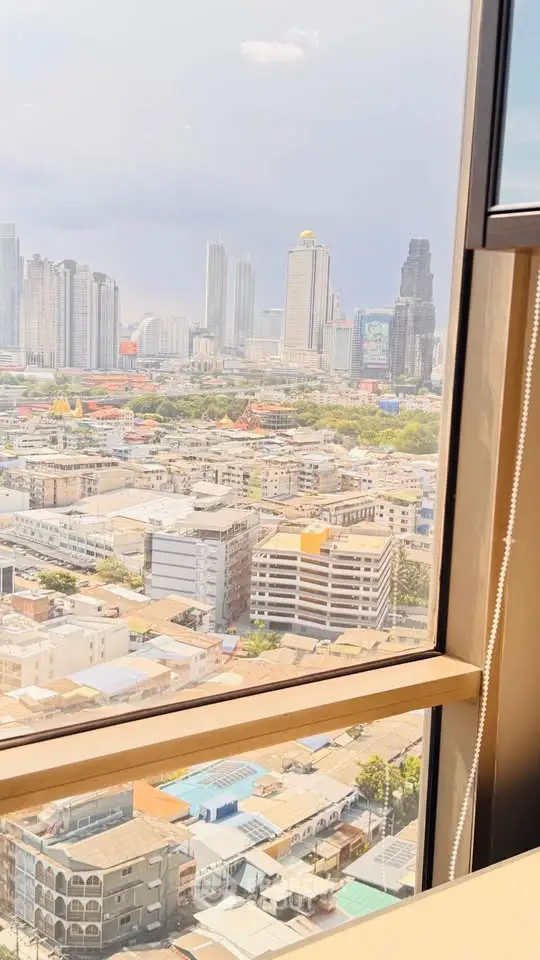 Stunning cityscape view from high-rise window showcasing urban skyline and architecture.