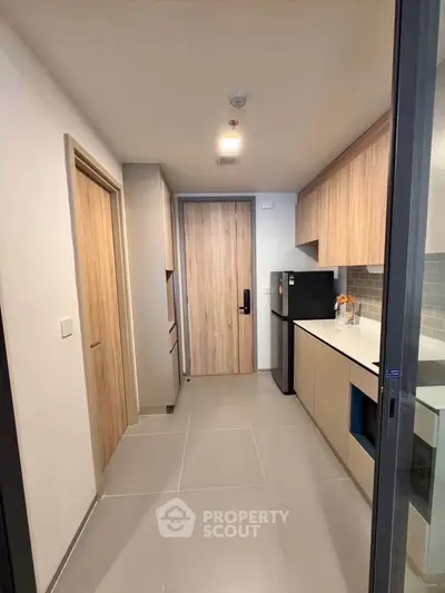 Modern kitchen with sleek cabinetry and integrated appliances in a contemporary apartment.