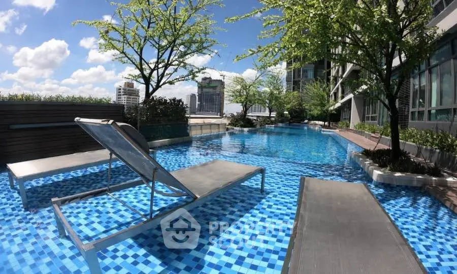 Luxurious rooftop pool with city skyline views and modern lounge chairs.