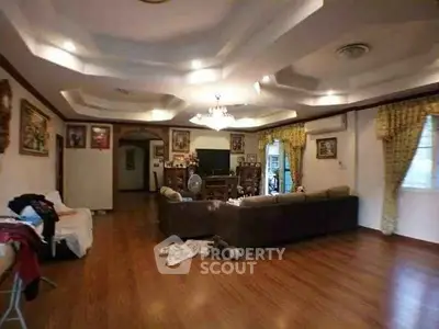 Spacious living room with elegant ceiling design and cozy seating area.
