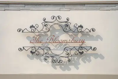 Elegant decorative sign for The Bloomsbury with intricate wrought iron design.