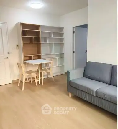 Modern living room with stylish furniture and wooden flooring, perfect for cozy gatherings.