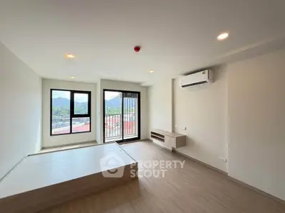 Spacious modern living room with large windows and mountain view