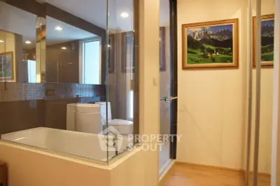 Luxurious bathroom with glass shower and elegant bathtub in modern apartment