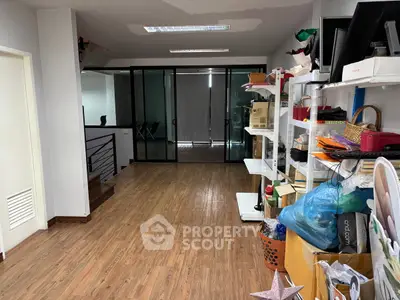 Spacious storage area with wooden flooring and ample shelving, ideal for organizing essentials.