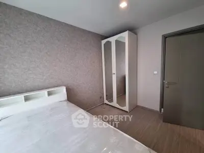 Modern bedroom with minimalist design and mirrored wardrobe